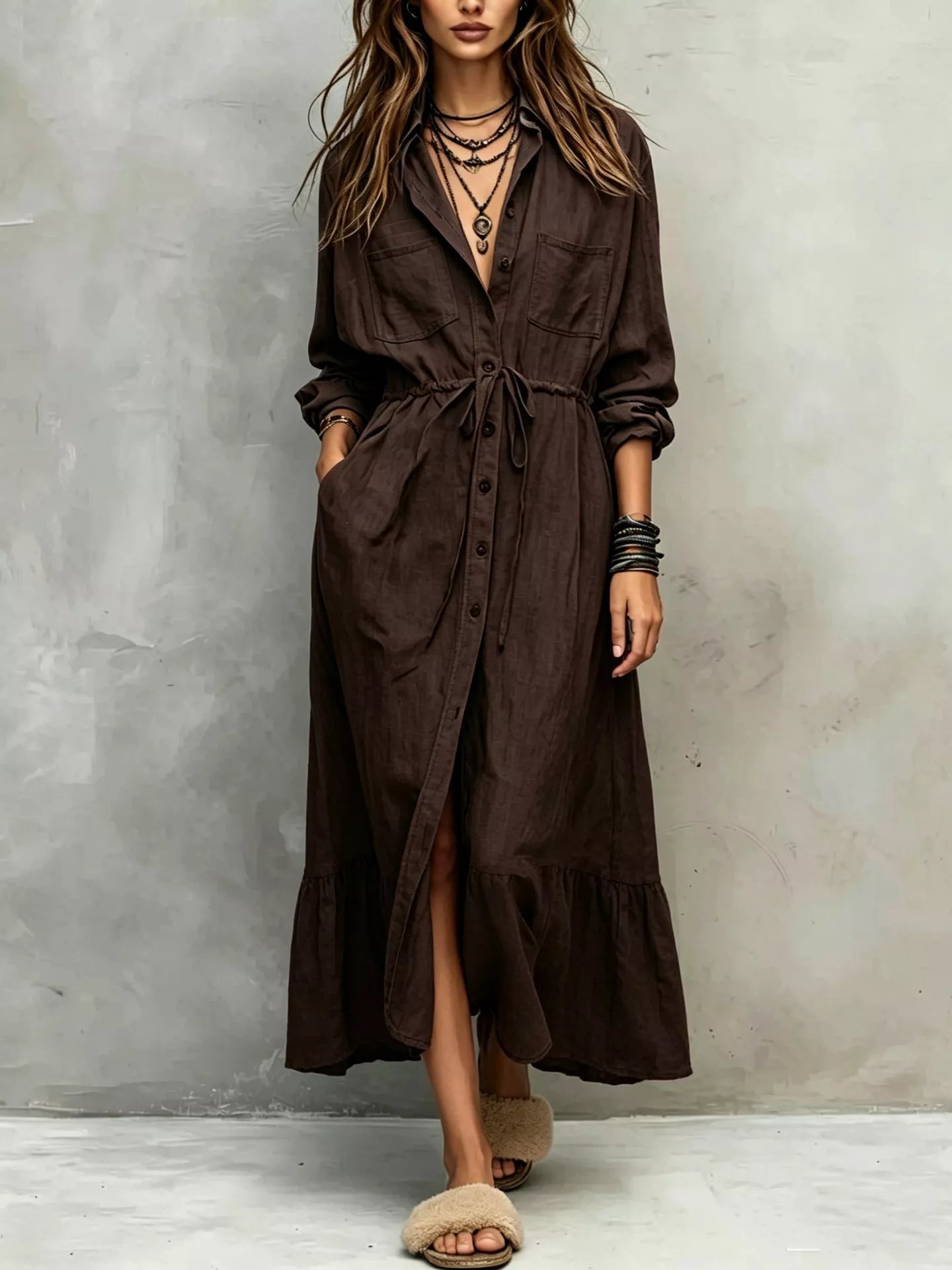 Plus size blue button-front shirt dress with long sleeves, drawstring waist, pockets, and side slit