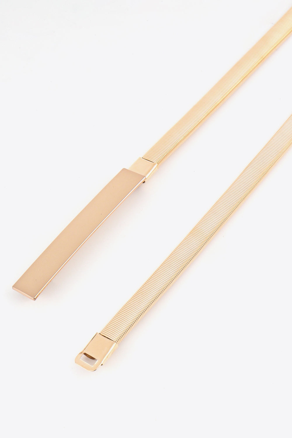 A gold-tone elastic iron skinny belt features a slender ribbed band and sleek rectangular buckle with a clean, polished finish.