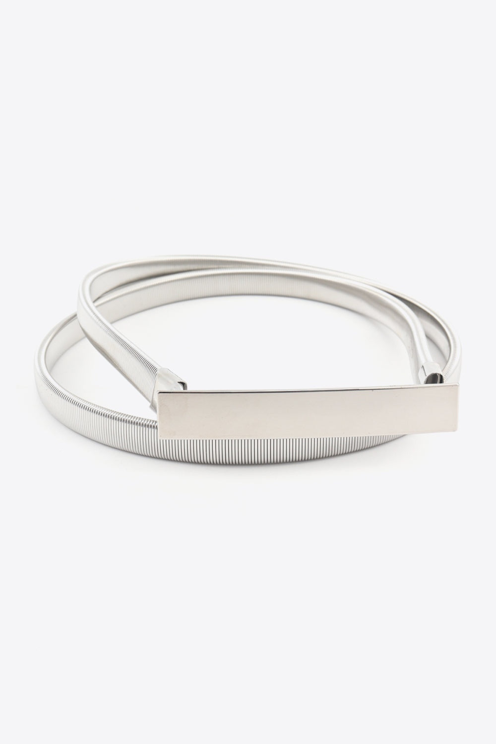 A silver iron elastic skinny belt features a slender ribbed construction and polished rectangular buckle for a refined, streamlined finish.