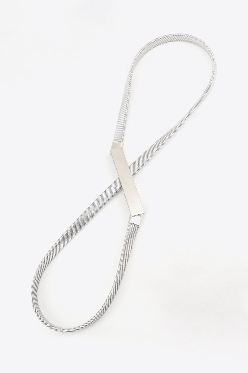 Slim silver-tone elastic iron skinny belt featuring a sleek flexible band and structured rectangular buckle for polished waist definition.