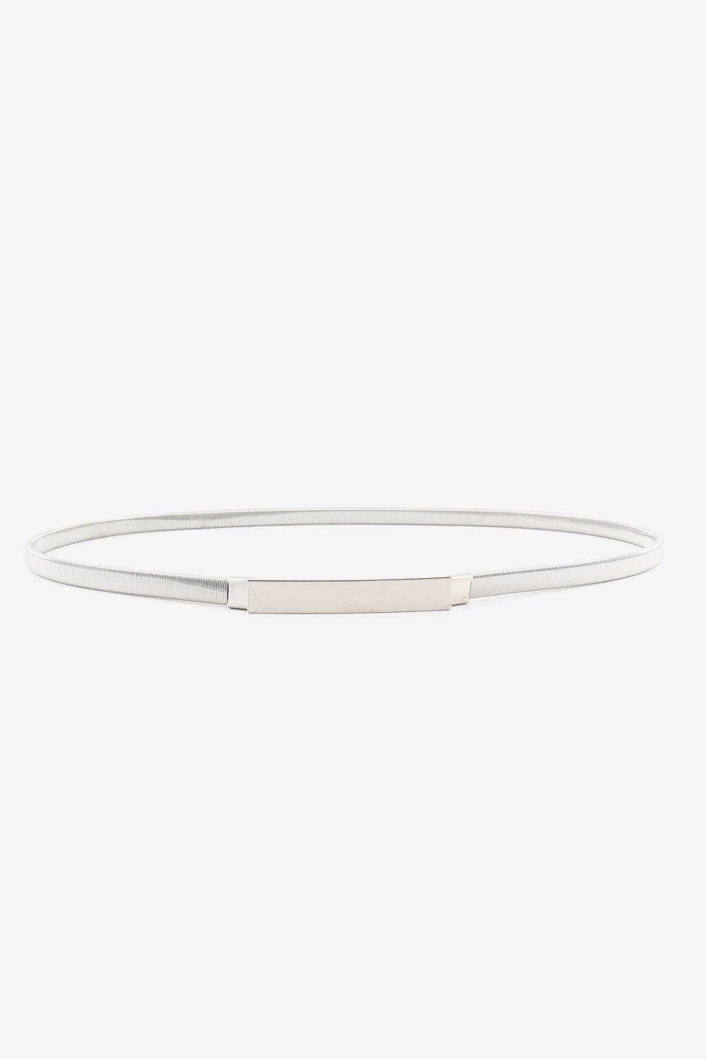 Slim silver iron elastic belt arranged in an oval, featuring a narrow ribbed band and clean rectangular buckle for a polished waist-defining finish.