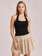 A model poses in a beige Elastic Waist Layered Skirt with a flowy, flared silhouette, gathered waistband, layered tiers, and delicate frill trim.