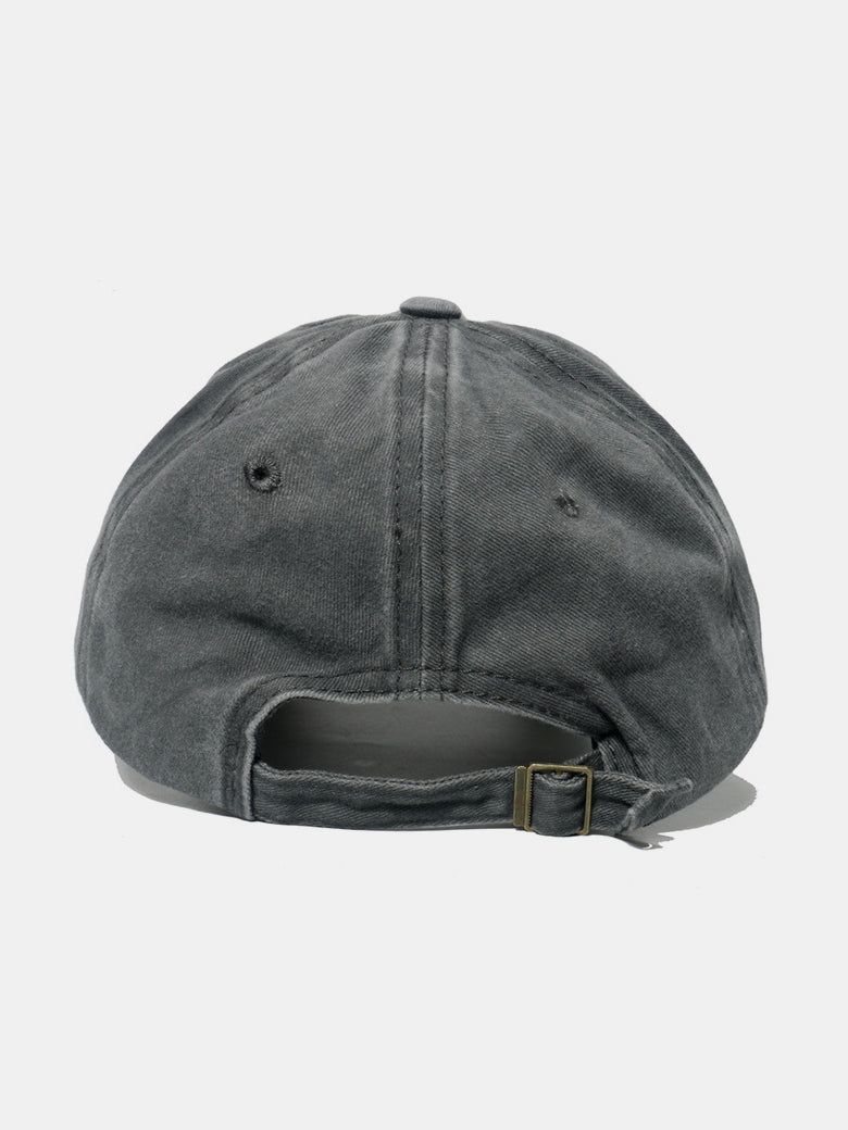 Back view of a washed charcoal cotton baseball cap showing its relaxed six-panel construction, tonal stitching, ventilation eyelets, and adjustable buckle strap.
