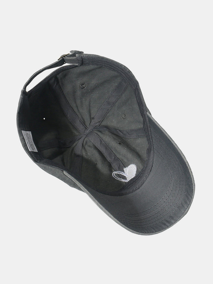 Black washed cotton baseball cap shown from the underside, featuring a six-panel construction, curved brim, tonal stitching, embroidered heart, and adjustable back strap.