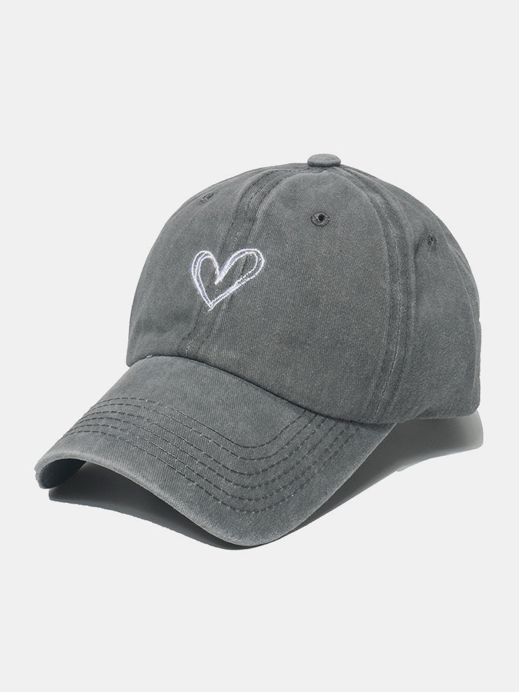 Gray washed cotton baseball cap with a six-panel construction, curved brim, tonal stitching, and an embroidered heart motif on the front.