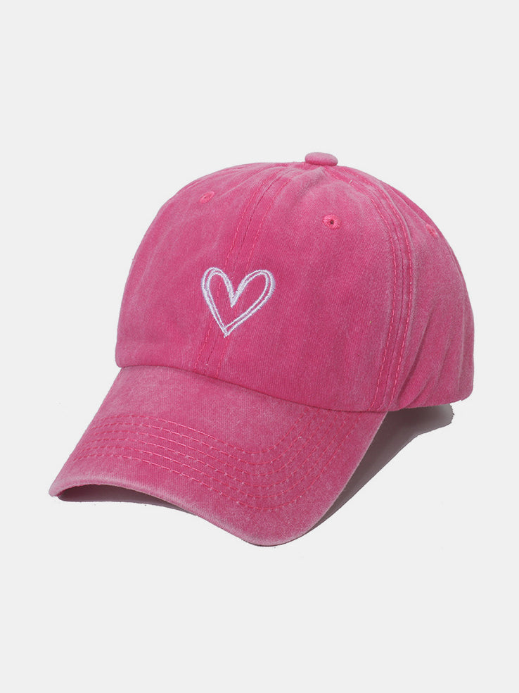 Pink washed cotton baseball cap with an embroidered heart, classic six-panel construction, tonal stitching, and a curved brim.