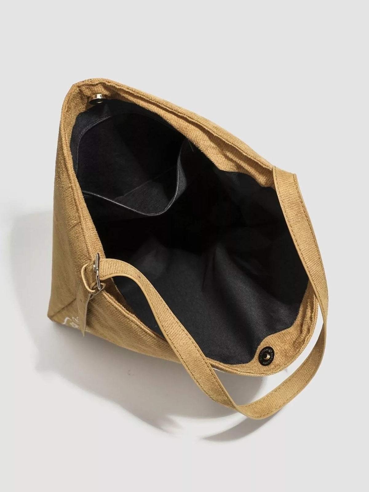 Open large tan suede handbag with long shoulder straps, a spacious black-lined interior, and an interior zippered pocket.