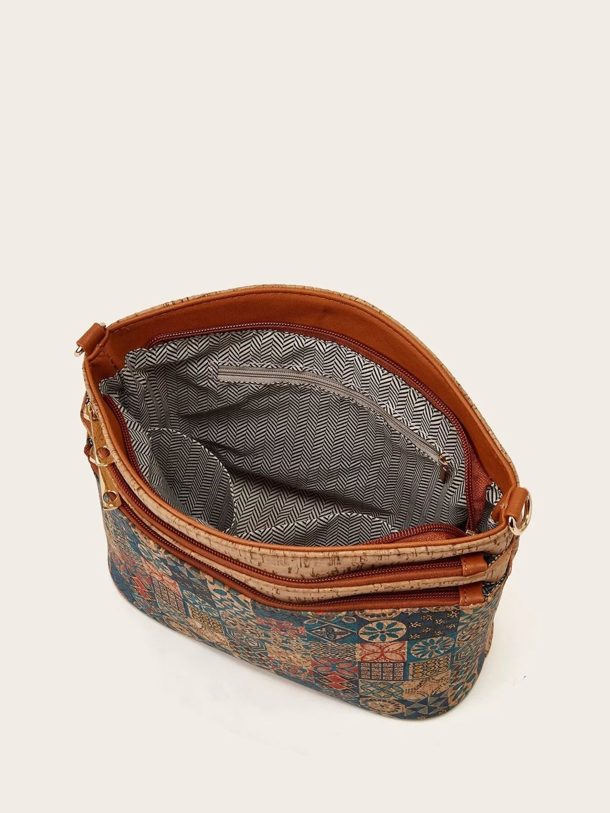 Medium PU leather crossbody bag with an ethnic geometric pattern, tree bark-style trim, multiple zip pockets, and a spacious striped interior.