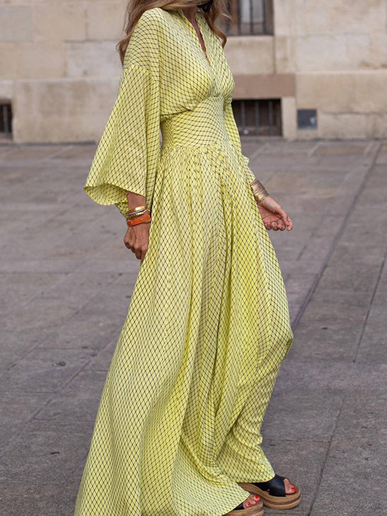 Flowy geometric maxi dress with V-neck and long sleeves in green, black, gray, red, and yellow
