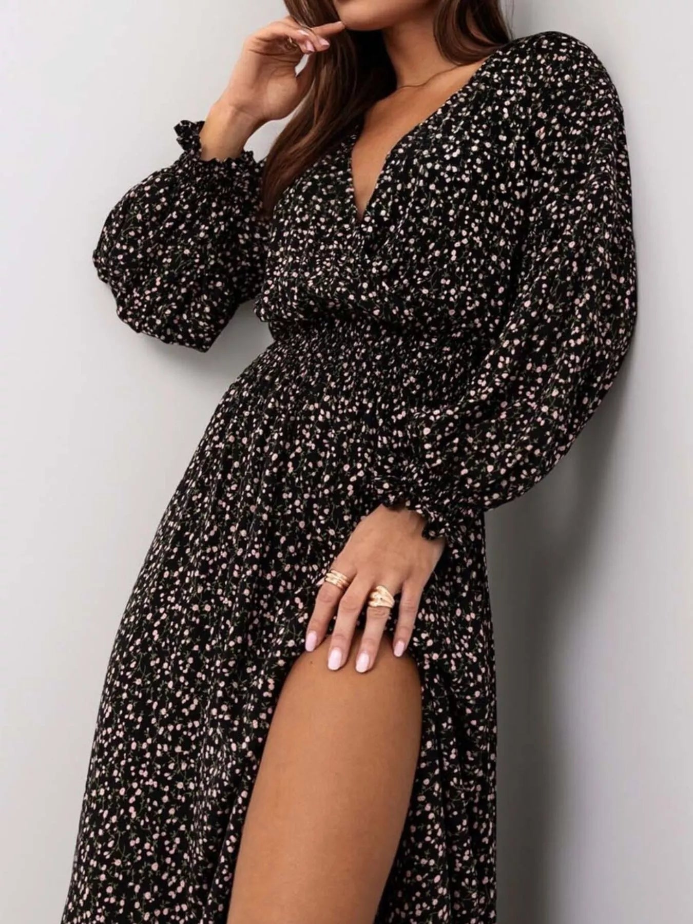 Bohemian floral printed maxi dress with plunging neckline, ruched waist, tiered skirt, and long flowy sleeves