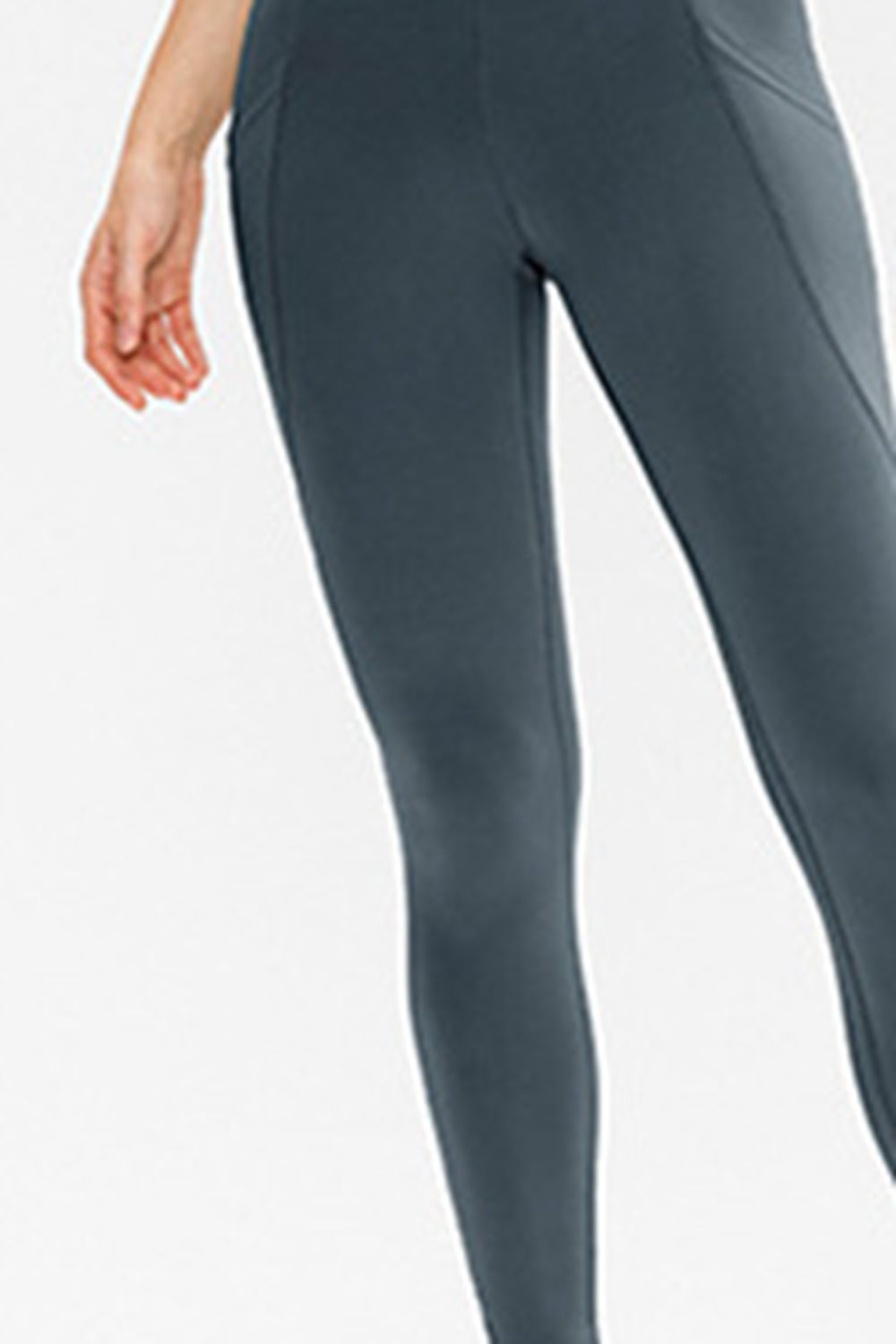 Standing model wears solid dark gray slim-fit active leggings with a stretchy tapered silhouette, long legs, and a subtle side pocket.
