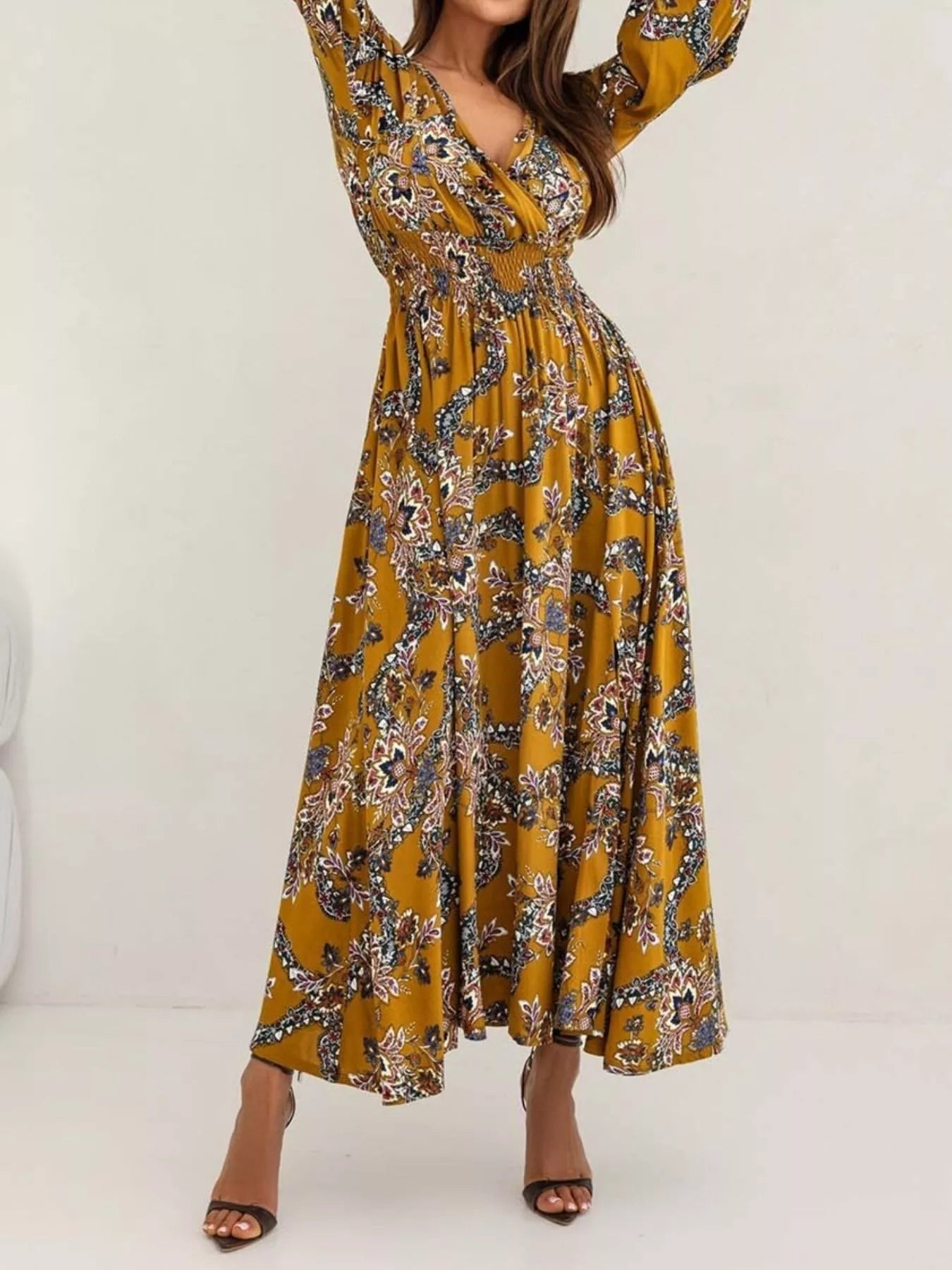 Bohemian floral printed maxi dress with plunging neckline, ruched waist, tiered skirt, and long flowy sleeves