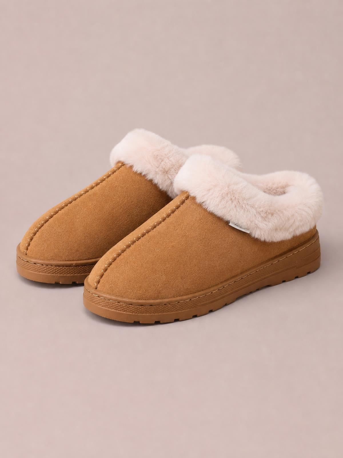 Tan suede faux fur round toe platform slippers feature plush white lining, stitched uppers, and sturdy rubber lug soles.