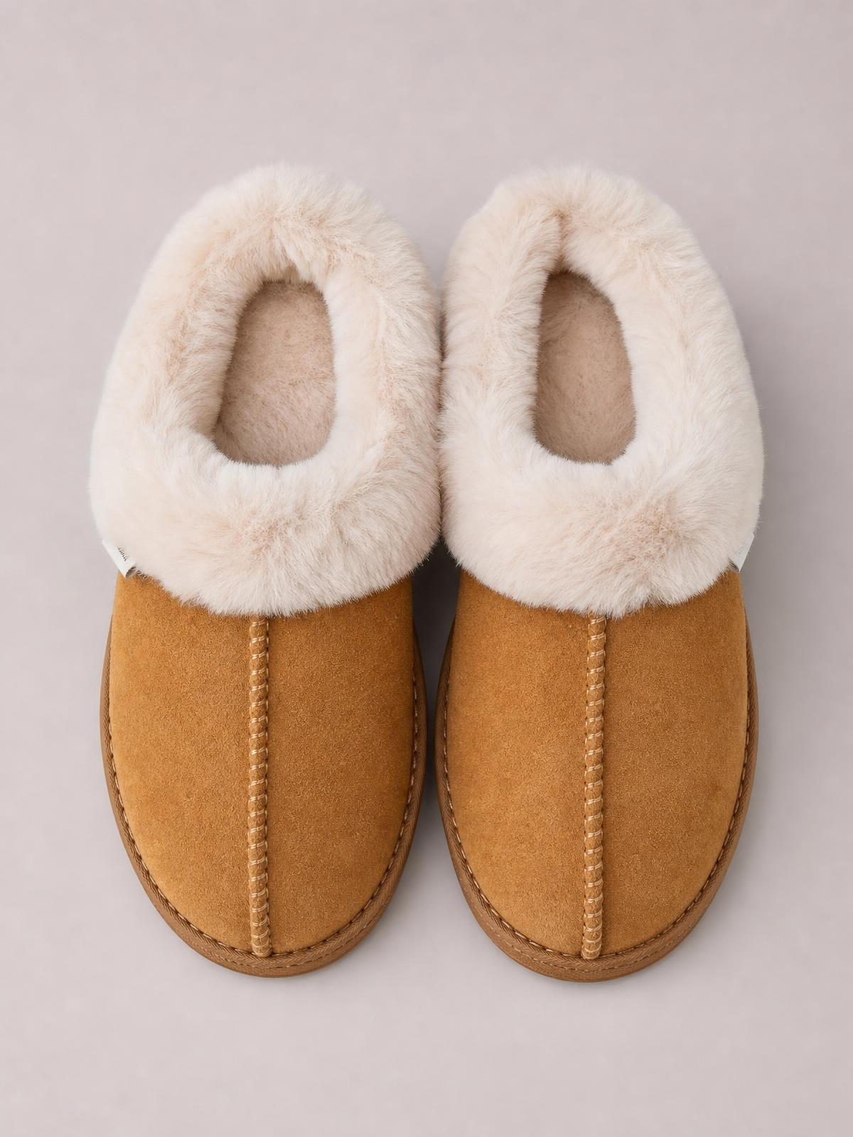 Tan round toe platform slippers feature soft faux fur lining, suede-like uppers, stitched center seams, and textured rubber soles.