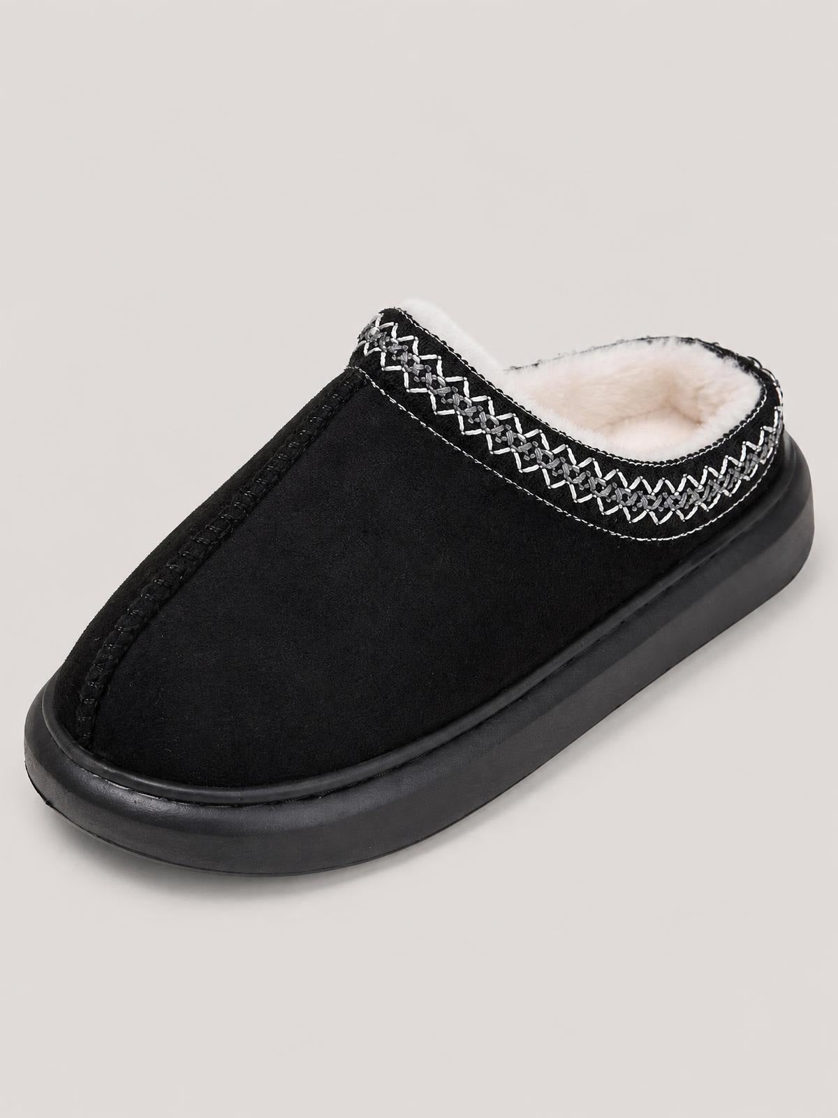Black suede platform slipper with a plush faux fur lining, decorative stitched trim, and a thick flat rubber sole.
