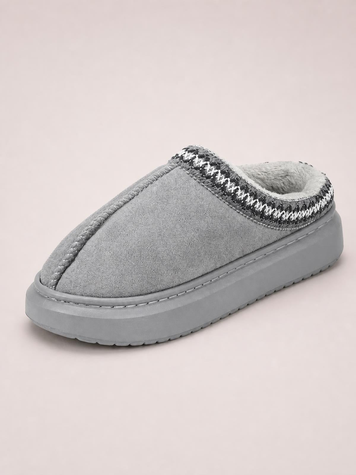 Gray suede platform slipper with a rounded toe, plush faux fur lining, contrast stitched trim, and a thick rubber sole.