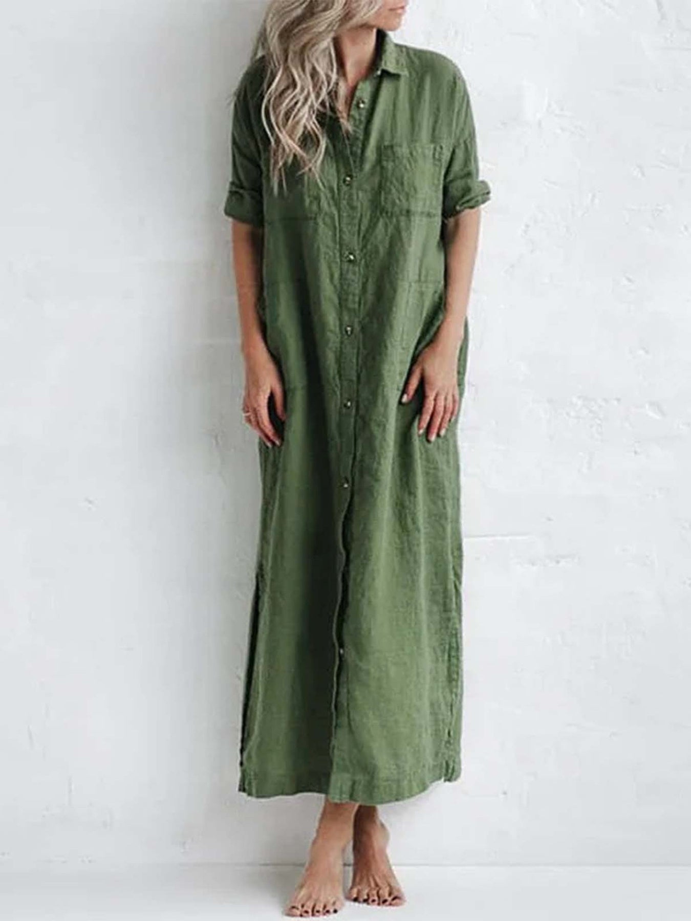 Plus-size green maxi shirt dress with collared neckline, button front, rolled sleeves, pockets, and side slit