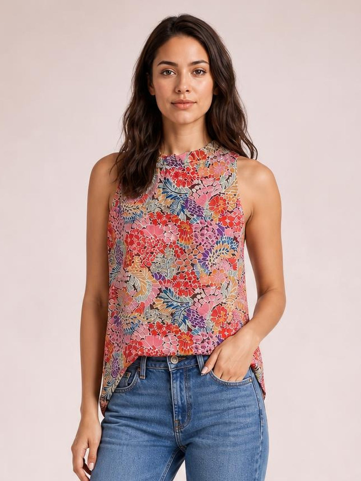 Model wearing a colorful floral print mock neck tank top with a sleeveless cut and relaxed regular-length silhouette, paired with jeans.