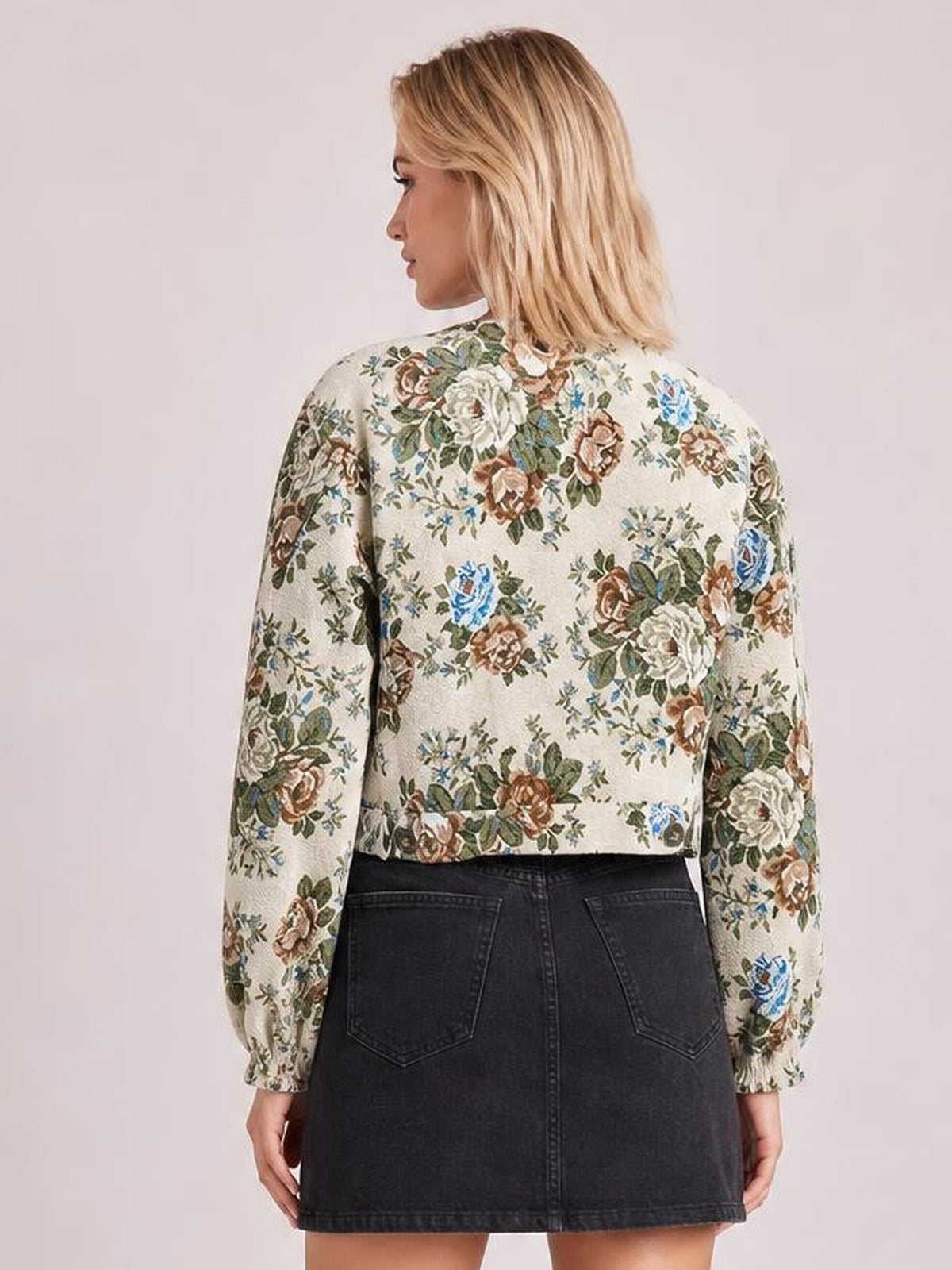 Model shown from behind wearing a cream floral print jacket with a contrasting white collar, long sleeves, and a cropped relaxed silhouette.