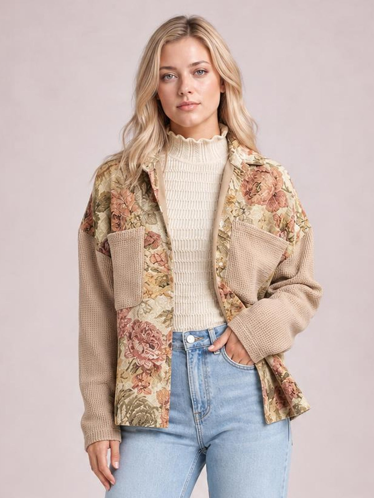 Model wears a relaxed beige floral patchwork jacket with waffle-knit sleeves, oversized chest pockets, and an open button-front silhouette.