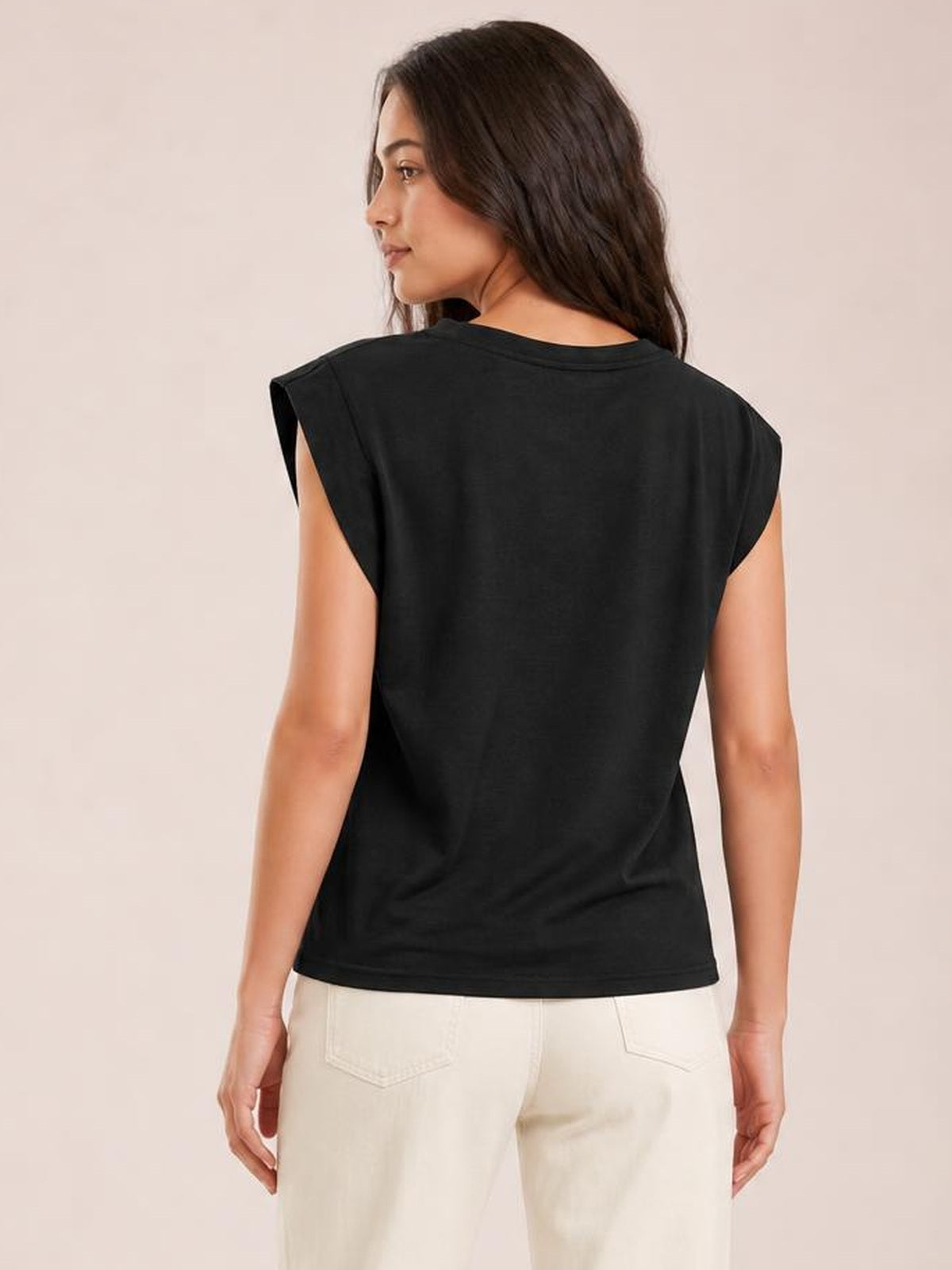 A model looks over her shoulder in a black Florira round neck cap sleeve T-shirt with a relaxed, straight silhouette and short sleeves.