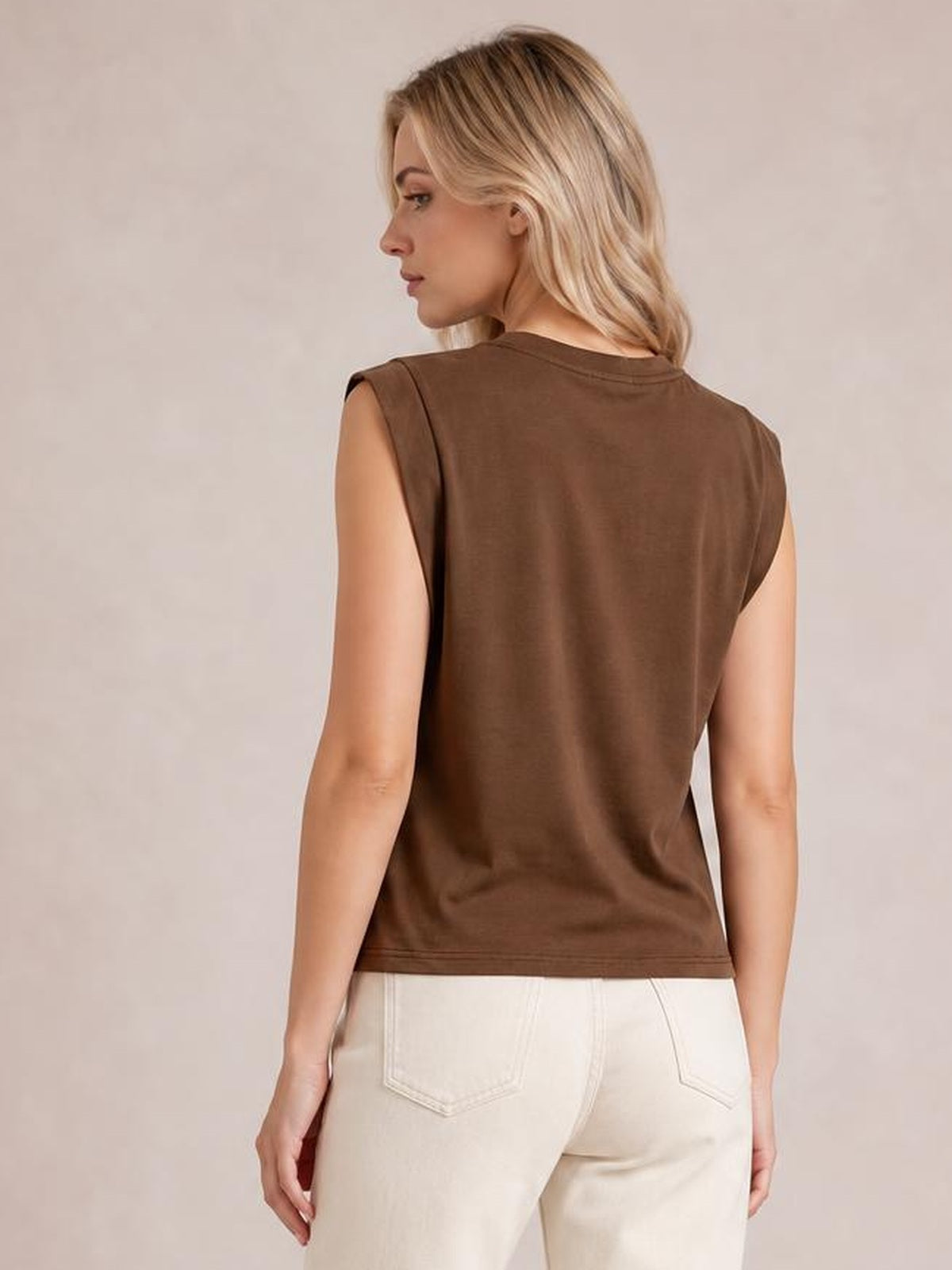A model shows the back of the brown Florira round neck cap sleeve T-shirt, featuring a straight silhouette, smooth construction, and clean hem.