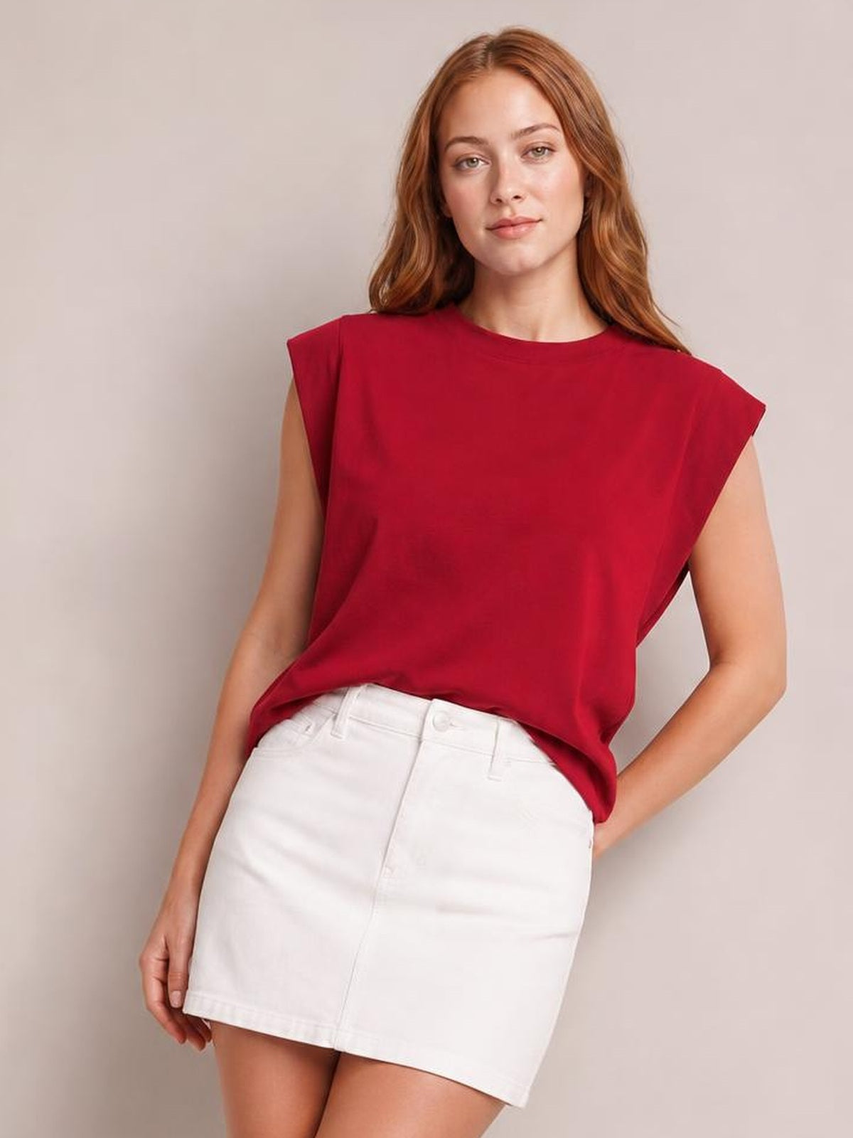 Model in a relaxed pose wears a red Florira round neck cap sleeve T-shirt with a loose, straight silhouette and slightly stretchy opaque fabric.