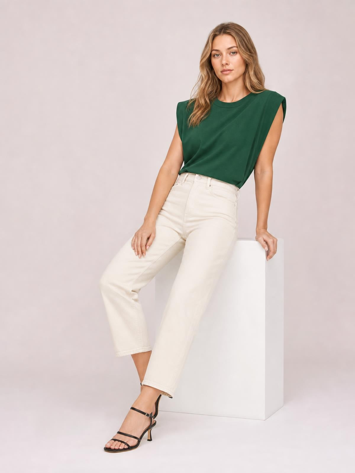 Model wearing a forest-green Florira round neck cap sleeve T-shirt with a relaxed silhouette, slightly tucked into high-waisted cream jeans.