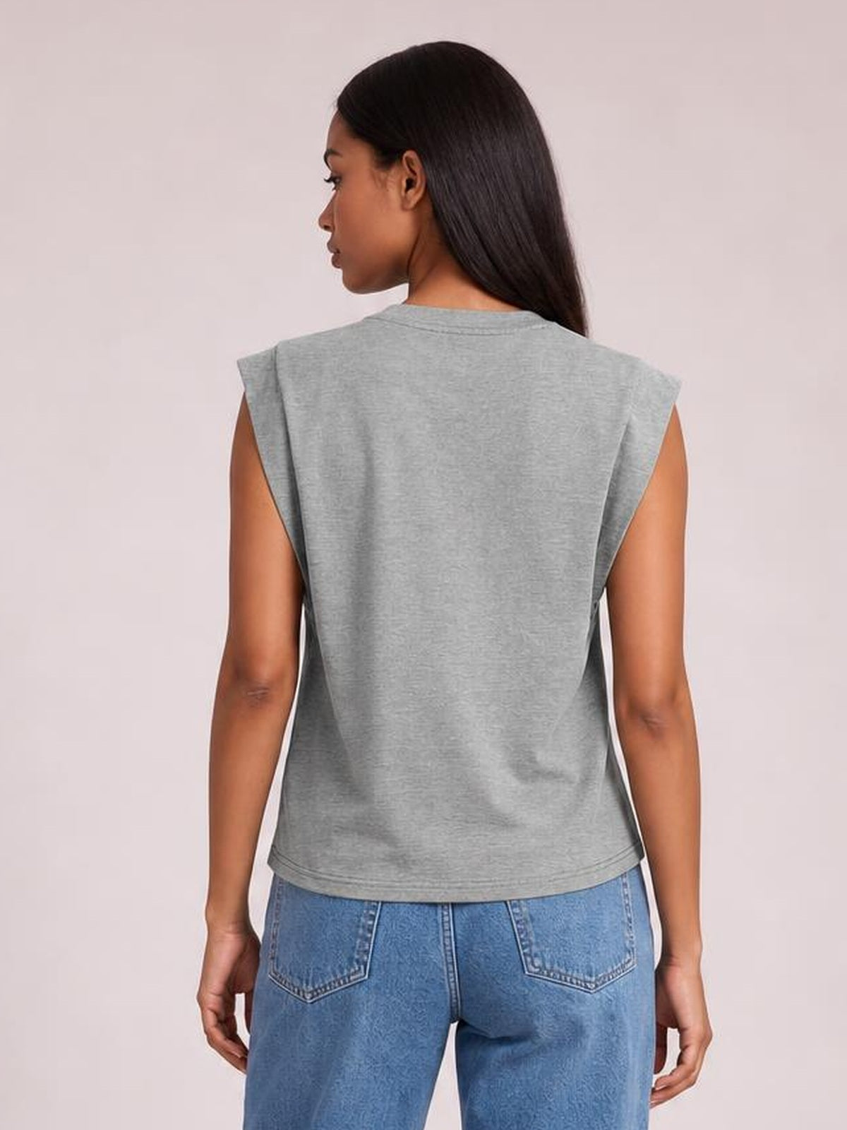 A model poses from the back wearing a gray Florira round neck cap sleeve T-shirt with a relaxed silhouette, straight hem, and visible double-stitched edging.