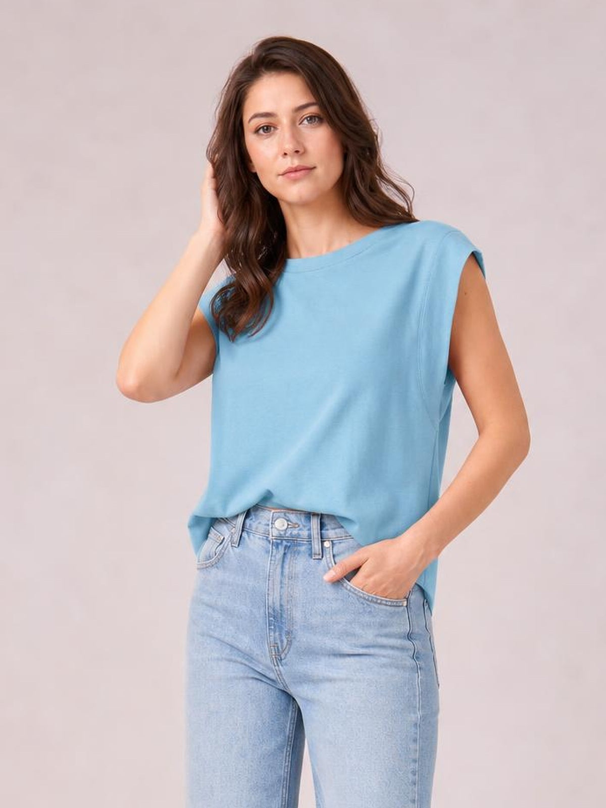 Model wearing a light blue Florira round neck cap sleeve T-shirt with a relaxed silhouette, short sleeves, and visible shoulder seam construction.