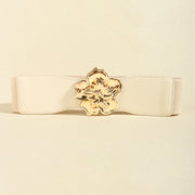 Cream wide elastic belt with a gently shaped silhouette, stitched edges, and a polished gold-tone alloy floral buckle at the center.