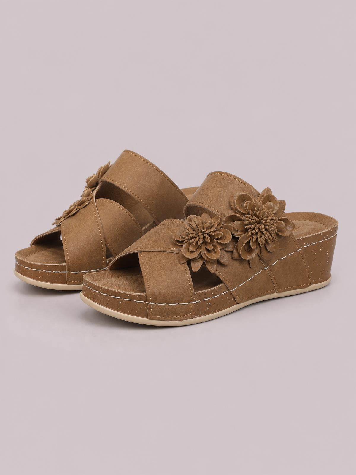 Brown Flower Crisscross wedge sandals feature wide open-toe straps, layered floral appliqués, stitched detailing, and a mid-height platform wedge sole.