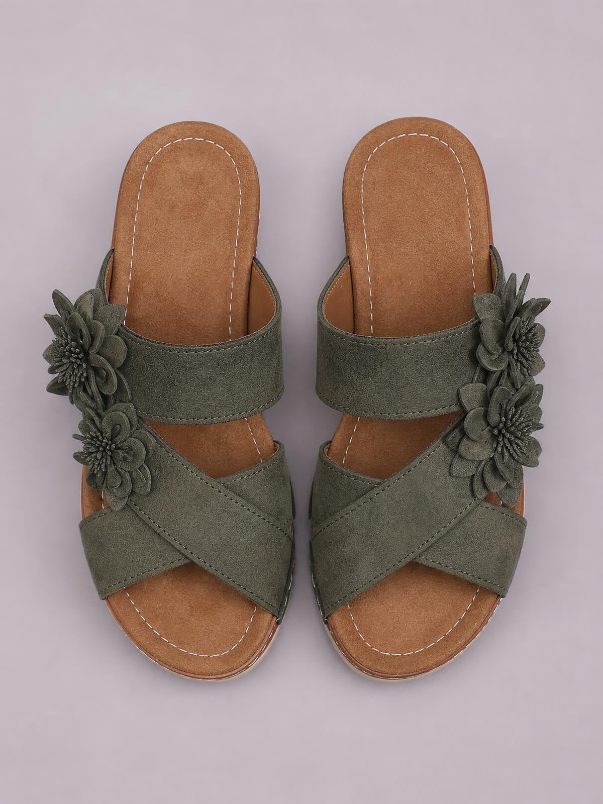 Olive-green Flower Crisscross Wedge Sandals feature open toes, layered floral appliqués, wide crossover straps, stitched brown footbeds, and mid-height wedge soles.