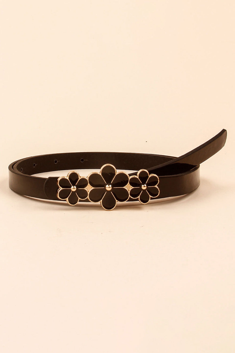 A skinny dark brown PU belt is coiled to show its adjustable holes and tapered end, finished with a clustered three-flower buckle in gold-tone trim.