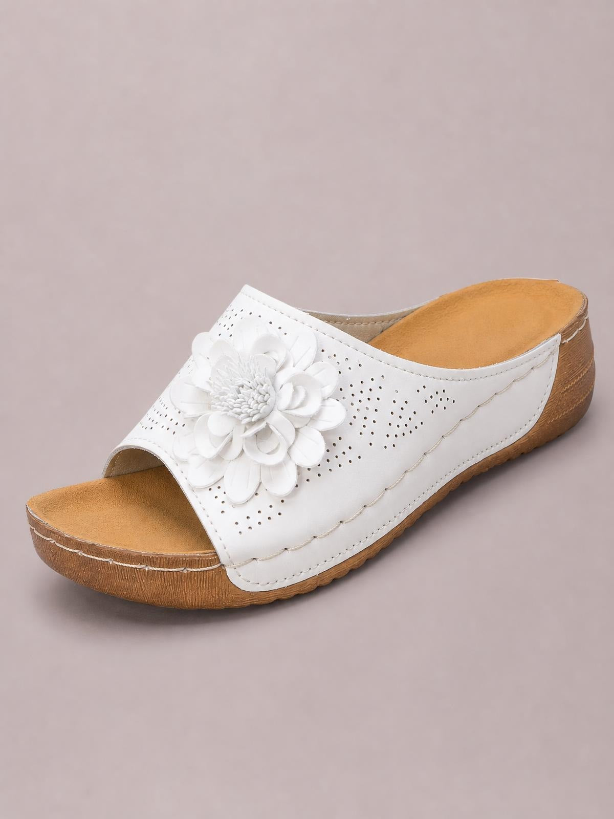 White flower peep-toe wedge sandal with a perforated PU leather upper, tan cushioned footbed, low wedge heel, and textured rubber sole.