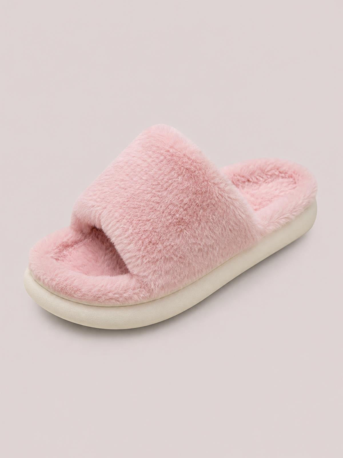 A pink fluffy open-toe comfort slipper features a wide plush strap, soft lining, and a thick cushioned flat sole.