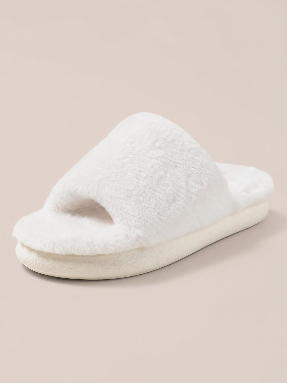 White fluffy open-toe comfort slipper with a wide plush strap, cushioned footbed, and thick flat rubber sole.