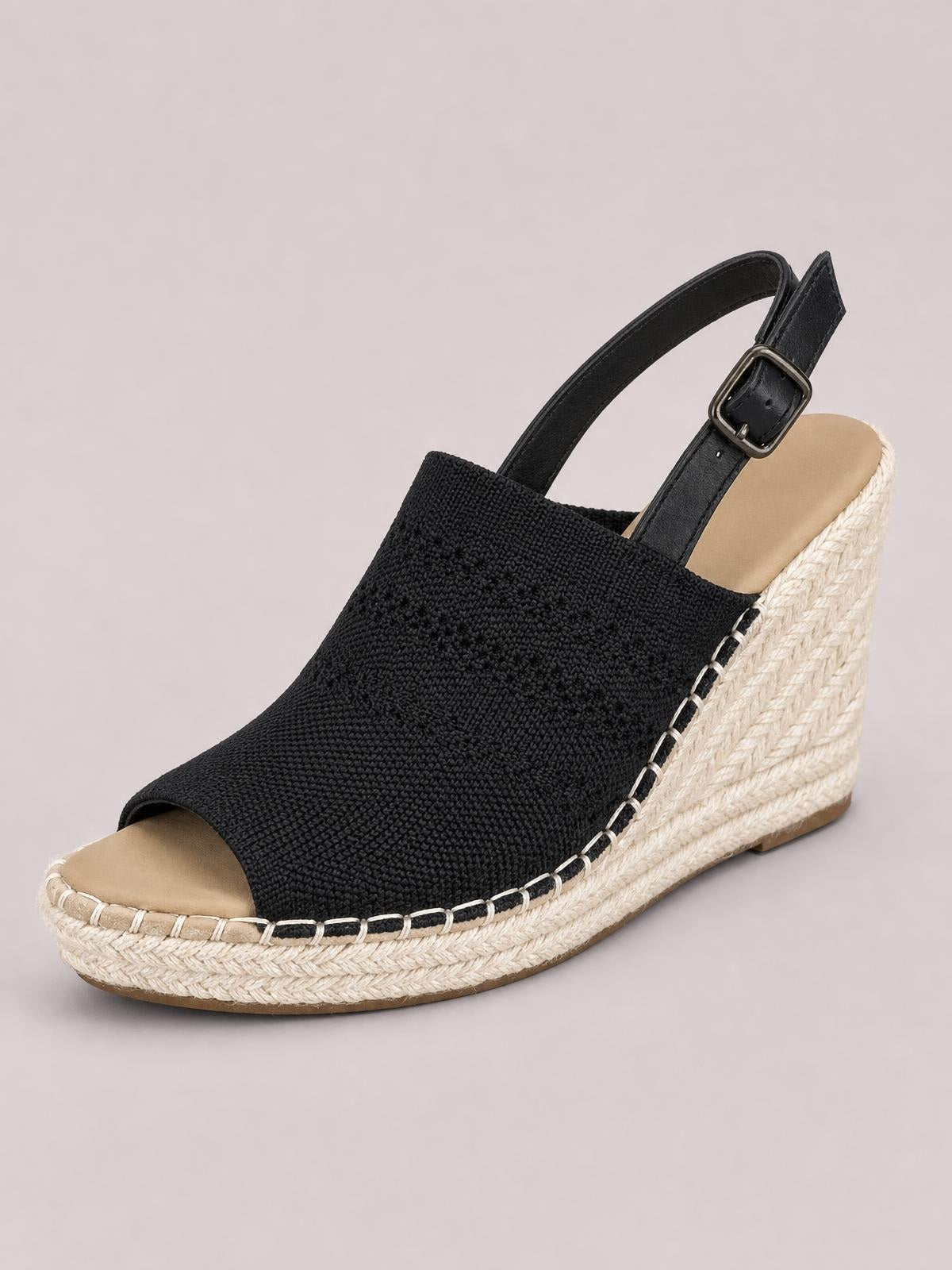 Black peep-toe high heel sandal with a textured upper, ankle strap and buckle, and a tall woven espadrille wedge sole.