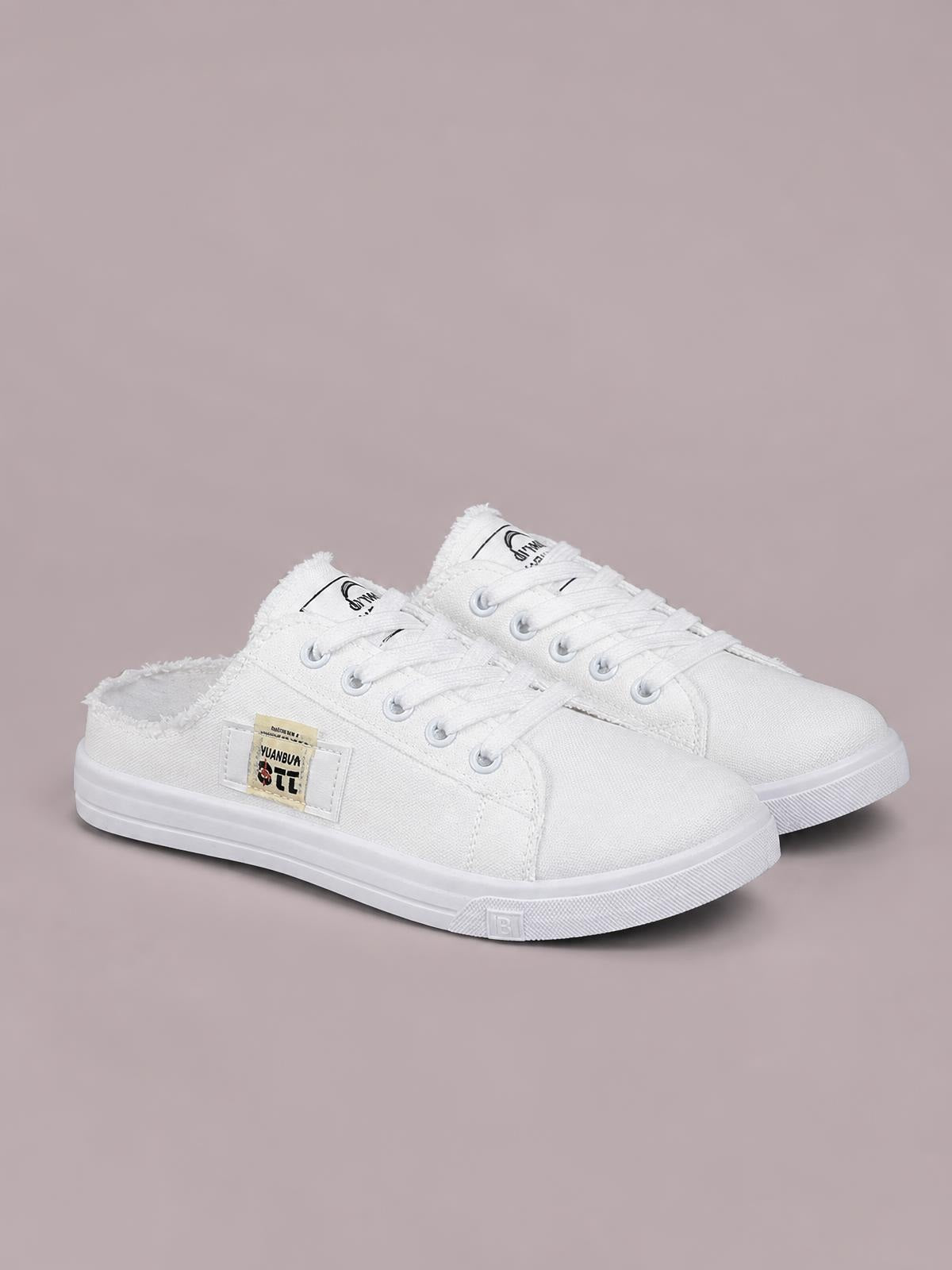 White canvas lace-up sneakers feature frayed collar edges, silver eyelets, rounded toes, and flat white rubber soles.