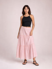 Model poses in a pink frill elastic waist skirt with a flowing tiered silhouette, gathered ruffle seams, and midi-length hem.
