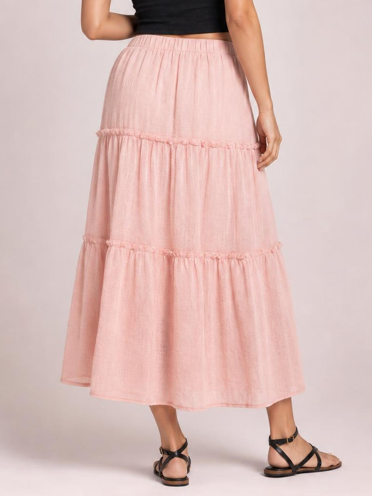 Model wearing a pink Frill Elastic Waist Skirt with a gathered waistband, tiered ruffle details, and a flowing ankle-length silhouette.