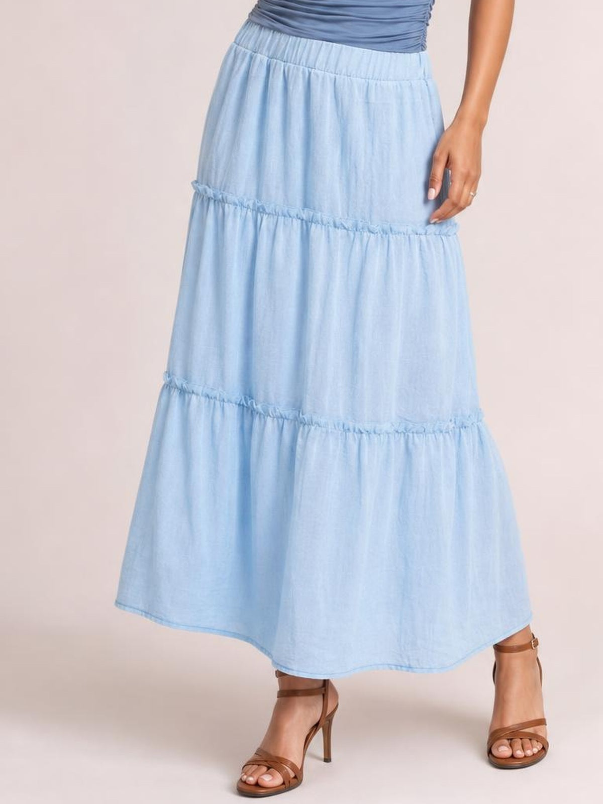 Model wears a light blue Frill Elastic Waist Skirt with a tiered, flowy silhouette, gathered frill seams, and a comfortable elastic waistband.
