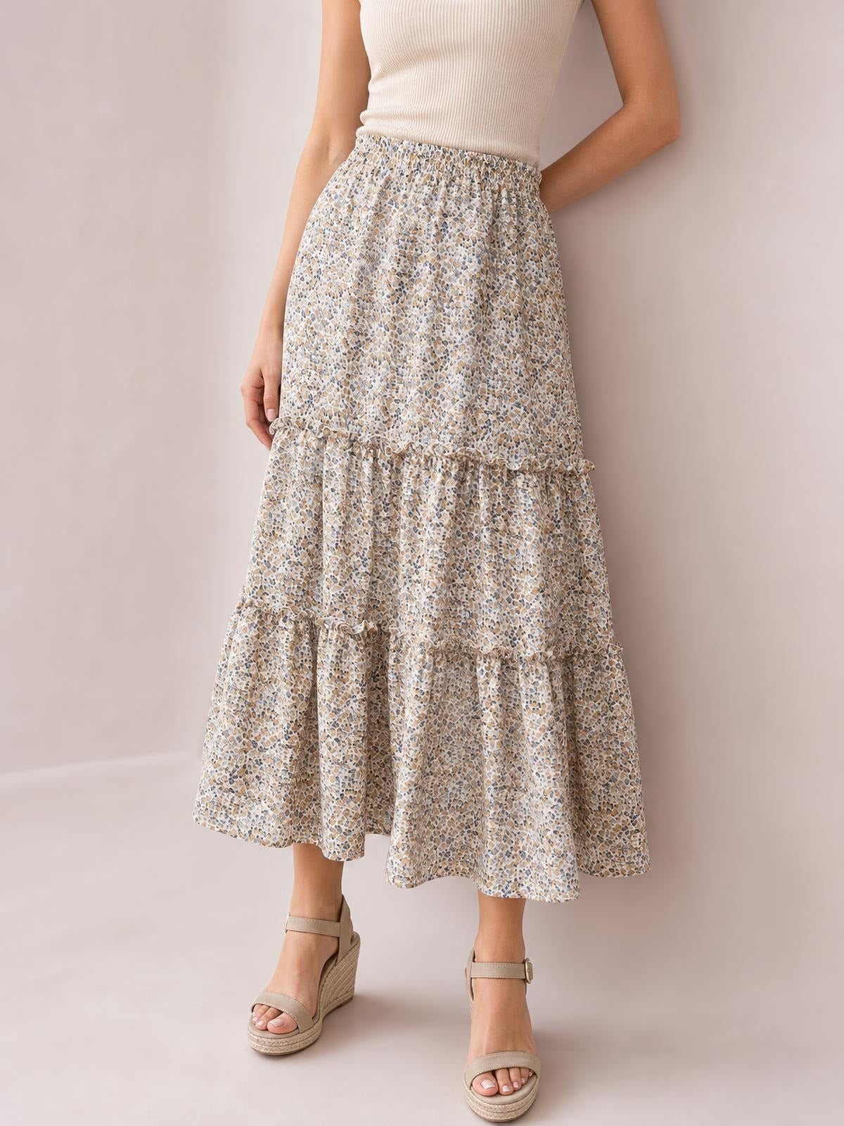 A model poses in a flowy cream Frill Tiered Printed Skirt with a beige, blue, and brown pattern, gathered waist, A-line silhouette, and layered frill tiers.
