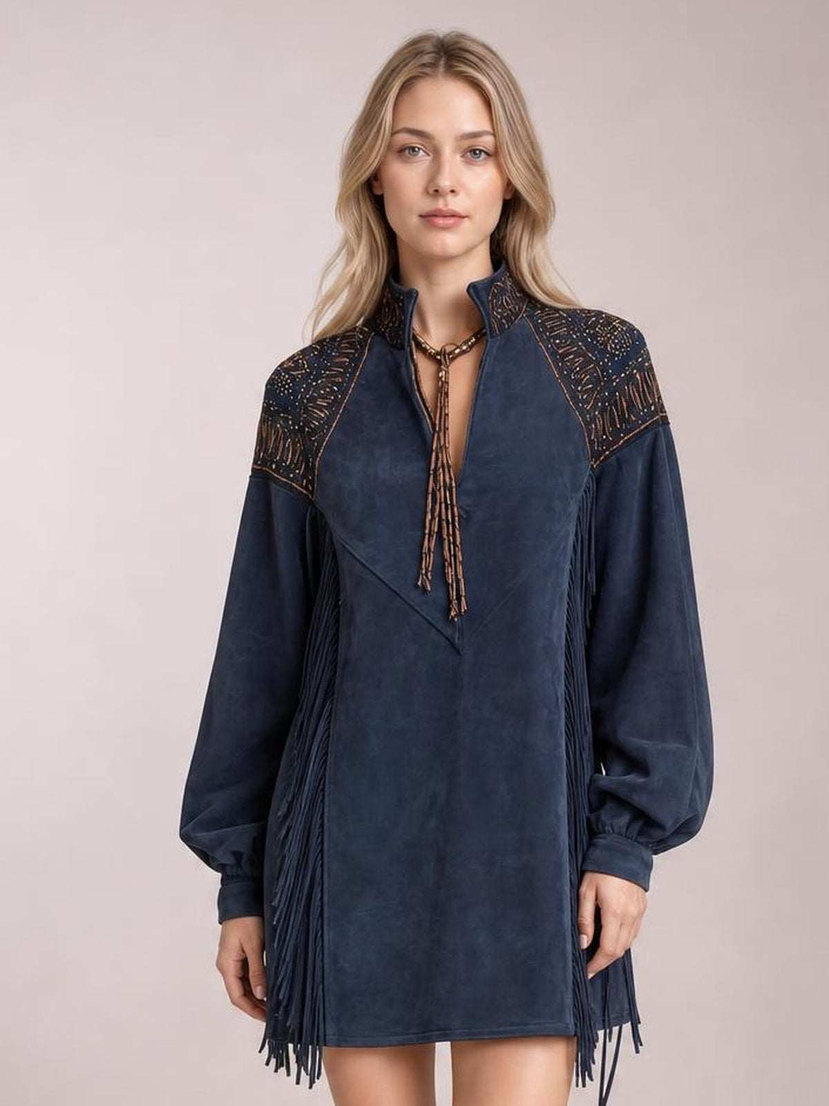 A front-facing model wears a navy fringed lantern sleeve mini dress with a high collar, embellished shoulder panels, and a straight, relaxed silhouette.