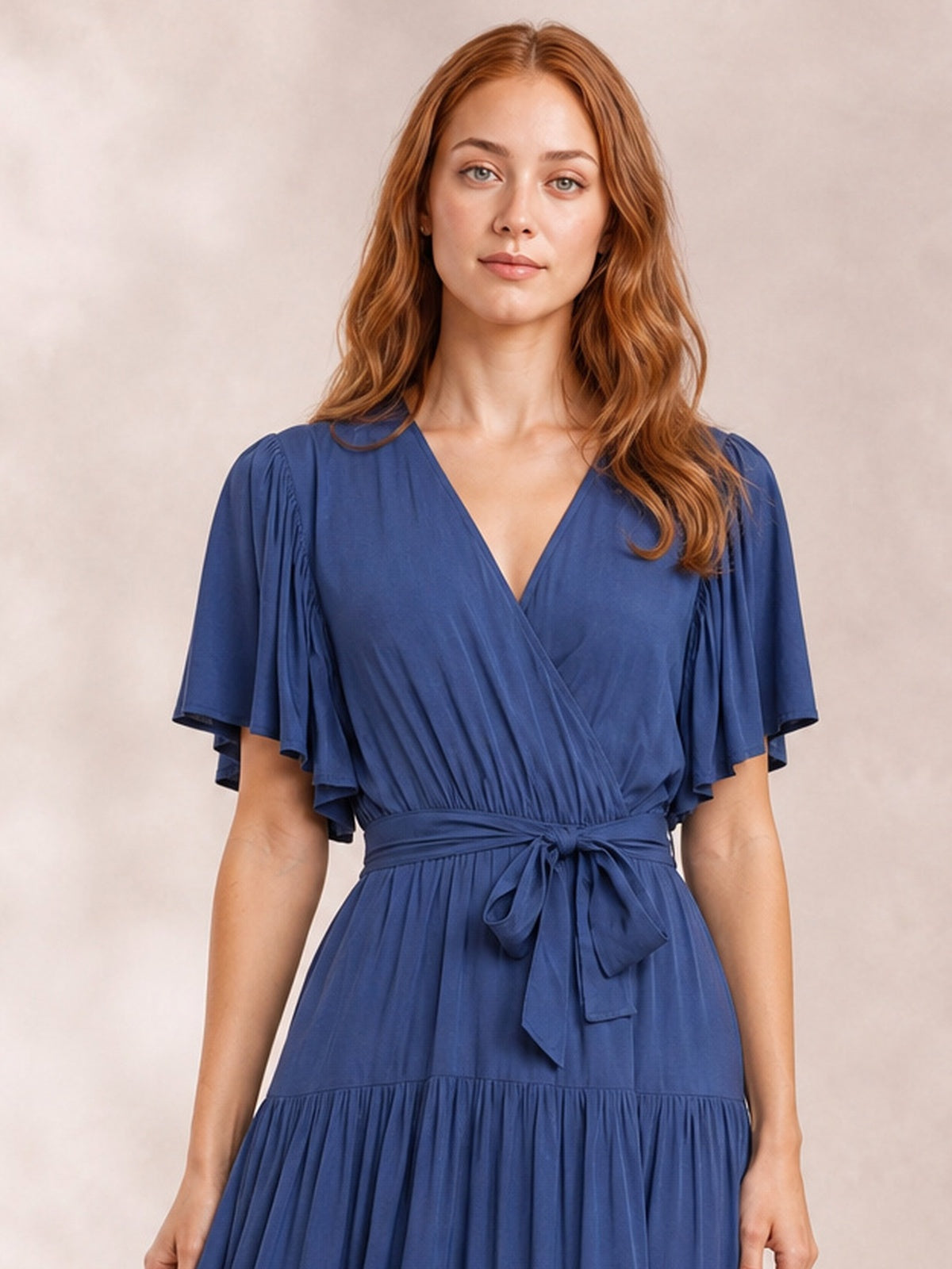 Model wears a navy Front Tie Short Sleeve Tiered Midi Dress with a V-neck, flutter sleeves, defined waist tie, and flowing gathered tiered skirt.