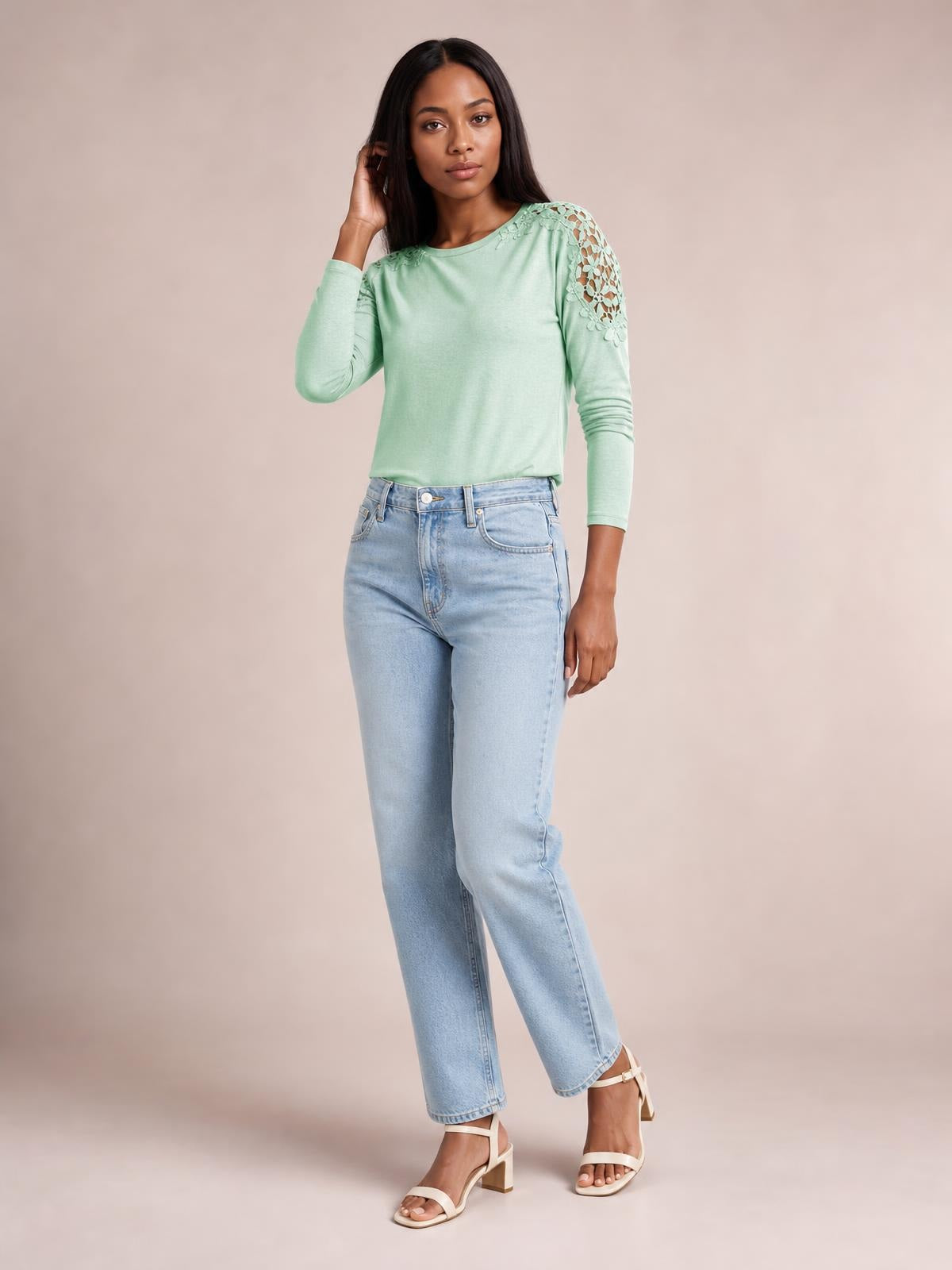 Model poses in a mint green cutout round neck long sleeve T-shirt with lace shoulder details and a relaxed, slightly stretchy silhouette.