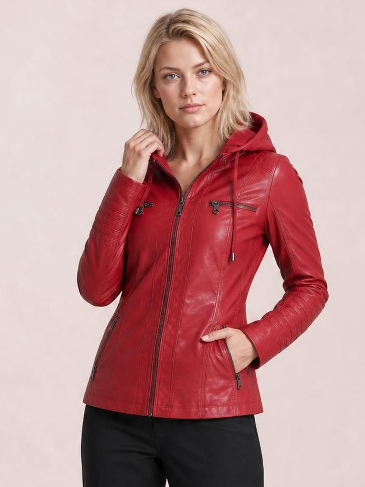 Model wears a red faux leather moto jacket with a hood, zip closure, seam detailing, zippered chest and hand pockets, and a regular silhouette.