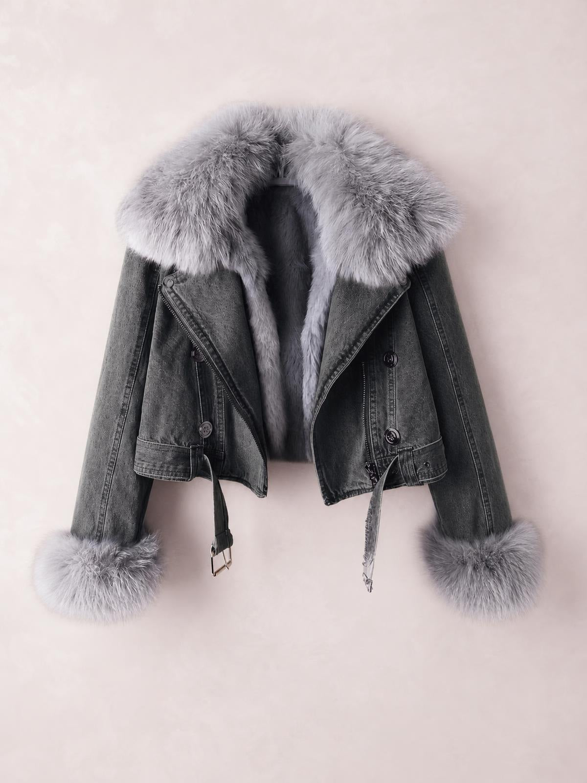 Dark gray denim jacket with a cropped silhouette, oversized faux fur collar and cuffs, asymmetric front zipper, button details, and hanging waist belt straps.