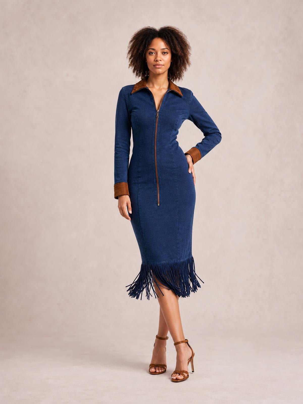 Model poses in a fitted navy midi dress with long sleeves, a full-length front zipper, contrasting brown collar and cuffs, and a dramatic fringe hem.