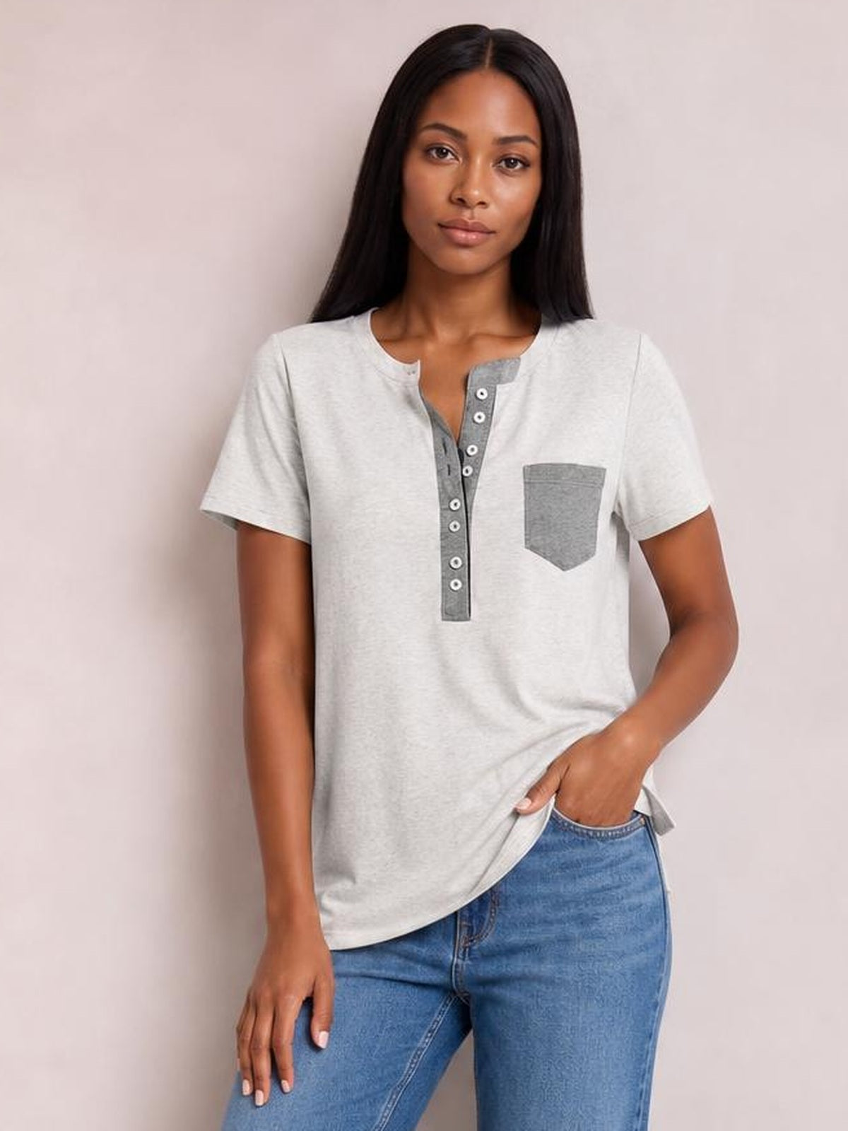 Model wearing a light gray half-button short-sleeve T-shirt with a darker button placket and chest pocket, shown in a relaxed standing pose.